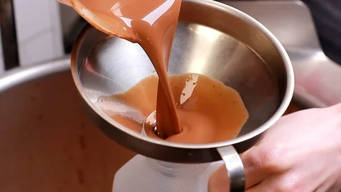 Chef prepared melted liquid white chocolate and mix liquid dark chocolate. Stock Footage 127534627