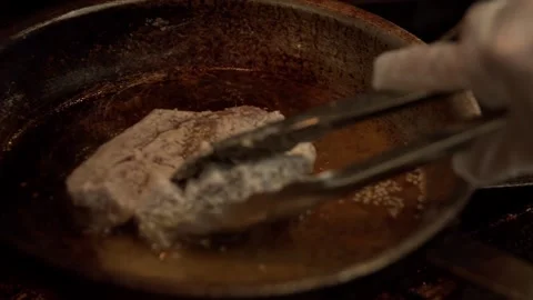 Chef prepares Ahi Tuning seared and basked on a professional kitchen stove Stock Footage 244740677