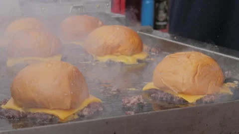 Chef prepares American-style appetizing smash burgers or cheeseburgers on a Stock Footage 301627215