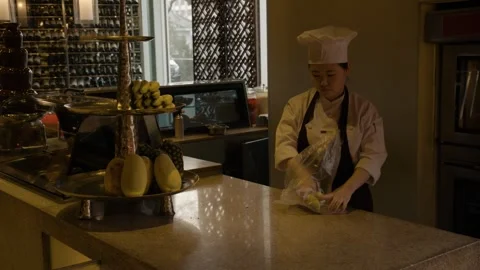 Chef Prepares and Arranges Fresh Fruit on Counter in Beijing Restaurant Kitchen Stock Footage 345777265