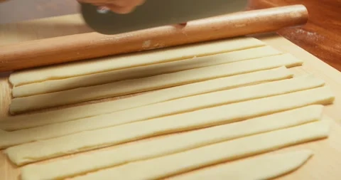 A chef prepares and cuts strips of dough for an apple pie to bake in the oven Stock Footage 318551185