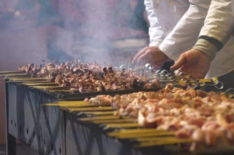 The chef prepares barbecue on the grill. traditional Caucasian dish cooked on Stock Photos