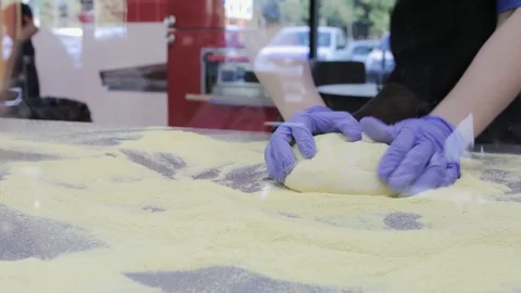 The chef prepares the basis for pizza from fresh dough in the cafe Stock Footage 119261744