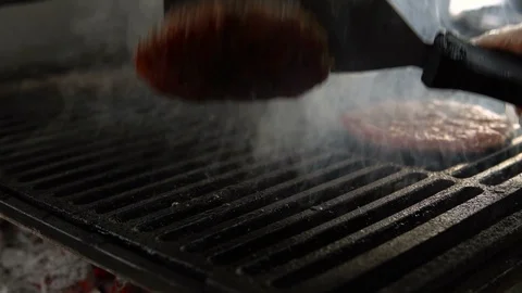 The chef prepares beef cutlet on the grill. A gloved hand turns the Patty over Vídeo Stock 103204541