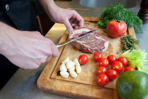 Chef prepares beef meat. Stock Photos
