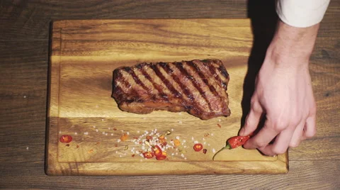Chef prepares a beef steak dish in a restaurant kitchen. Close up Stock Footage 62079651