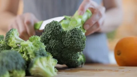 The chef prepares broccoli for fresh green detox food Stock Footage 102617752