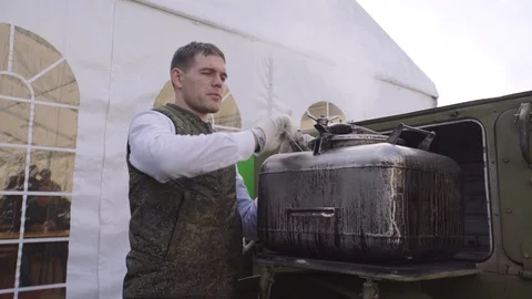 Chef prepares buckwheat in field kitchen. Buckwheat porridge. Military field Stock Footage 98374265