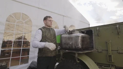 Chef prepares buckwheat in field kitchen. Buckwheat porridge. Military field Stock Footage 98374294