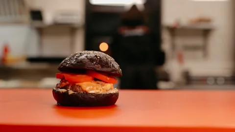 The chef prepares a burger. Beef, pork, cucumber, sauce and onion. Stock Footage 158171364