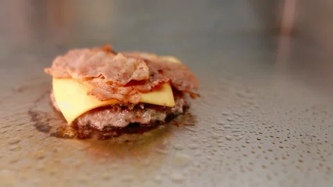 The chef prepares a burger. Beef, pork, cucumber, sauce and onion. Stock Footage 158171495
