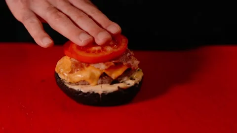 The chef prepares a burger. Beef, pork, cucumber, sauce and onion. Stock Footage 158171619