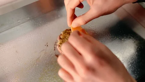 The chef prepares a burger. Beef, pork, cucumber, sauce and onion. Stock Footage 158171644