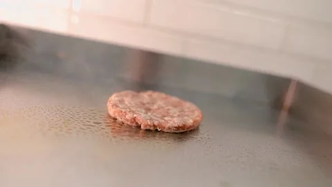 The chef prepares a burger. Beef, pork, cucumber, sauce and onion. Stock Footage 158171918
