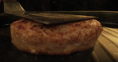 Chef prepares burger patty on a grill. Hamburger or cheeseburger preparation Stock Footage 293539680