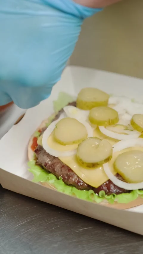 The chef prepares a burger puts a bun Stock Footage 171412489