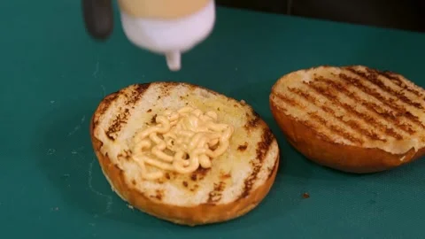 Chef prepares a burger. Slow motion. Video stock 303745834