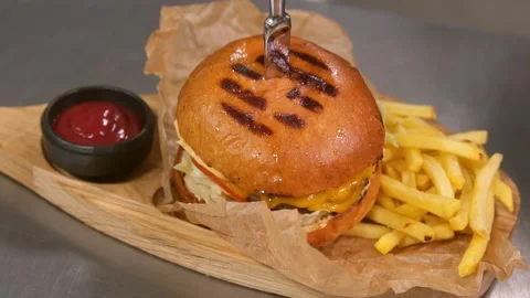 Chef prepares a burger. Slow motion. 스톡 동영상 303745954