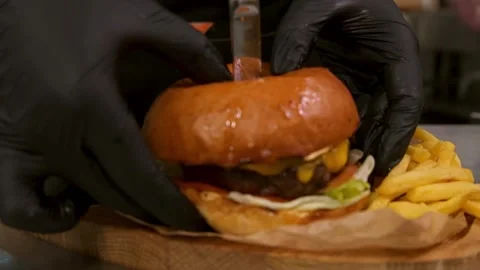 Chef prepares a burger. Slow motion. 스톡 동영상 303746163