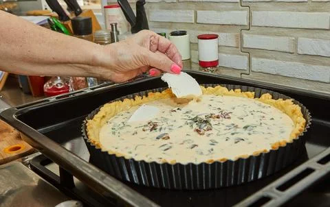 Chef prepares Cheese Pie before baking in the electric oven Stock Photos