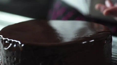 The chef prepares a chocolate cake in icing for dessert, decorates Stock Footage 131231229