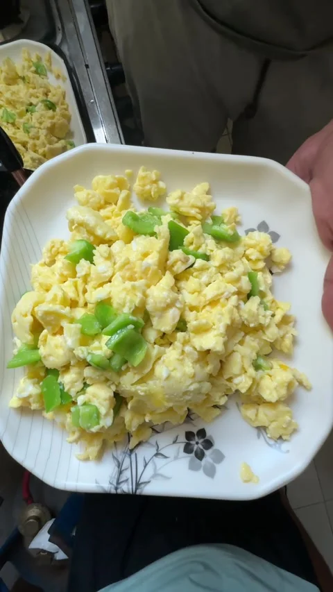 A chef prepares creamy scrambled eggs on toasted bread with fresh salad, close Stock Footage 340546066