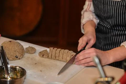 Chef prepares cut dough from sweet ingredients in the kitchen Photos