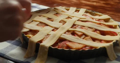 A chef prepares a delicious apple pie to bake in the oven. Baking an apple pie Stock Footage 318551194