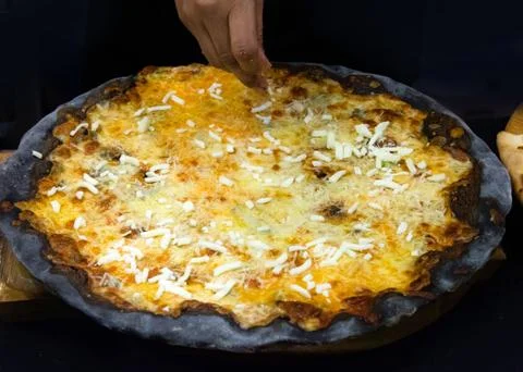 Chef prepares delicious pizza on the kitchen Stock Photos