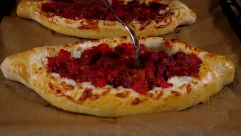 The chef prepares delicious pizza from vegetables, cheese sausage and eggs Stock Footage 137798204