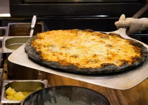 Chef prepares delicious pizzas on the kitchen Stock Photos