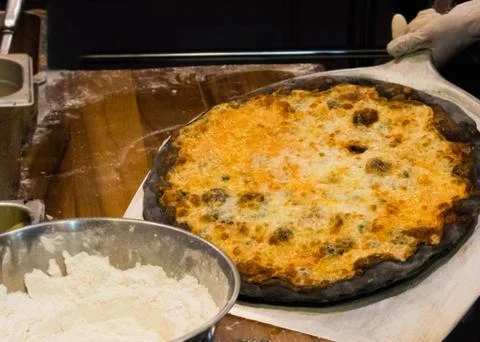 Chef prepares delicious pizzas on the kitchen Stock Photos