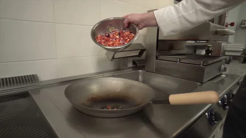 The chef prepares delicious vegetables in a stainless pan in a high-tech kitchen Stock Footage 112632509