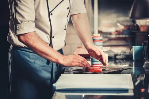 Chef prepares dish in the kitchen Stock Photos