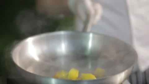 The chef prepares a dish of meat and potatoes in a frying pan Stock Footage 154205028