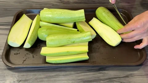 A chef prepares a dish with zucchini using a kitchen food processor, slicing  Stock Footage 305389484