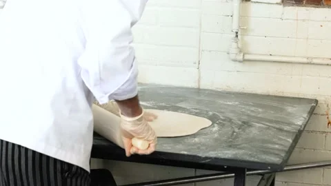 Chef prepares the dough with flour to make pizza Stock Footage 153607908