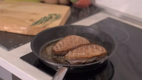 The chef prepares duck breasts in a pan Stock Footage 110034606