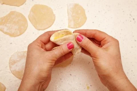 Chef prepares dumplings with curd Stock Photos