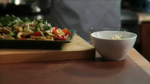Chef prepares flambes Asian food Stock Footage