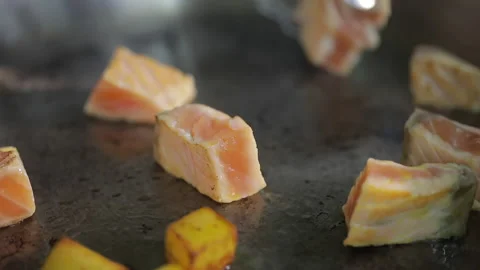 The chef prepares fried fish in a frying pan Stock Footage 154205302