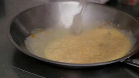 A chef prepares fried pieces of meat, peppers in a huge wok in a restaurant - a Stock-Footage 147916443