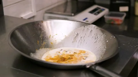A chef prepares fried pieces of meat, peppers in a huge wok in a restaurant - a Stock-Footage 147916609