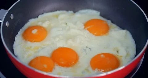 The Chef Prepares Frying Eggs, Cook in Butter, Seasoned With Salt and Black Stock Footage 103620937