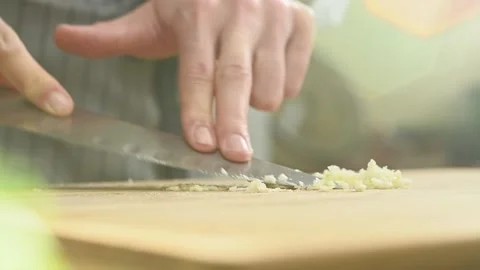 Chef prepares garlic paste on wooden cutting board. Stock Footage 151689935