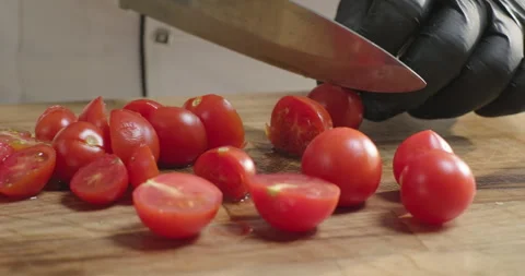 Chef prepares healthy dish, cuts vegetables cherry tomatoes on the wooden Stock Footage 277765629