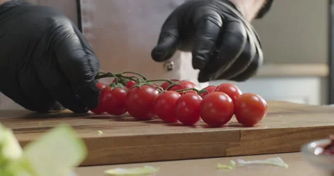 Chef prepares healthy dish, separates cherry tomatoes from a branch on the Stock Footage 277954838
