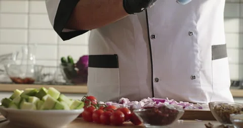 Chef prepares healthy meal, drops chopped onion on the cutting board. Chef Stock Footage 279256659