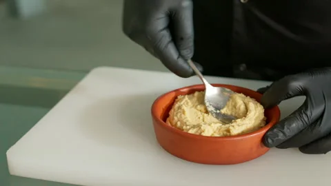 The chef prepares the hummus Stock Footage 136999437