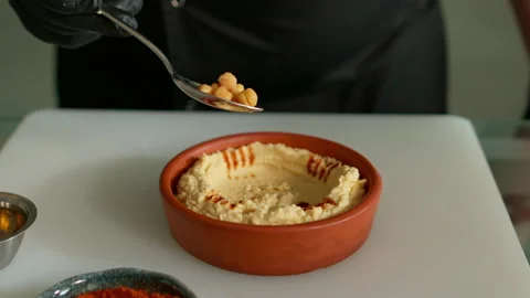 The chef prepares the hummus Stock Footage 136999561